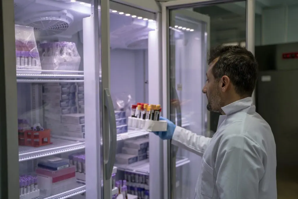 Custom Scientific Freezers Manufacturer 1 A scientist reviews samples in the custom scientific freezer