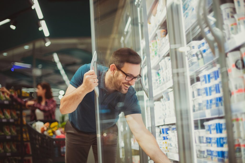 Image of a man opeing a commercial efrigerator for beverages