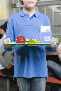 Boy with a milk carton on a tray