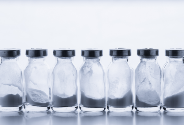 A row of glass medical vaccine bottles