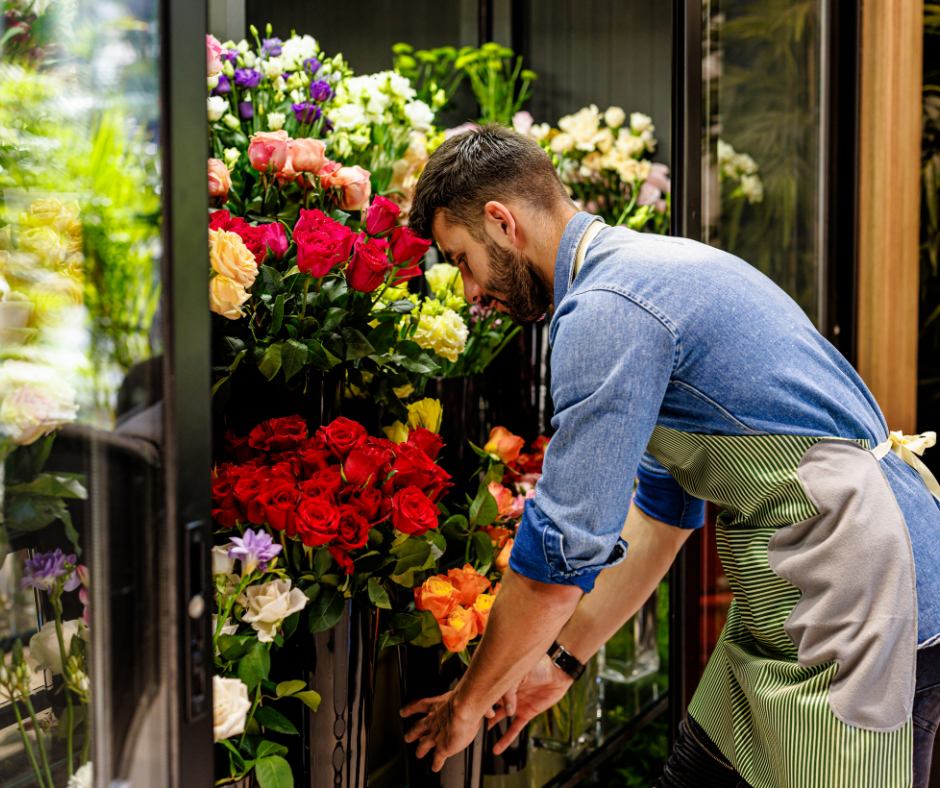 Image of a man arranging fresh flowers in a Flower Refrigerator